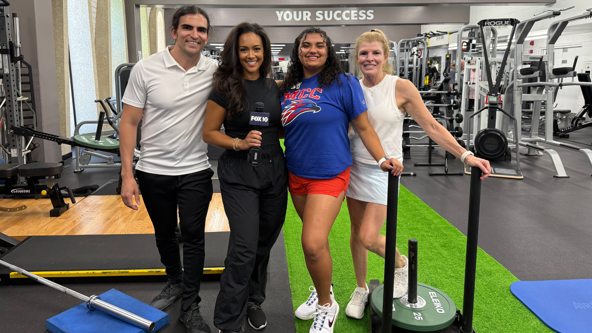 Four people pose together inside the Mesa Community College Fitness Center during a FOX 10 News 