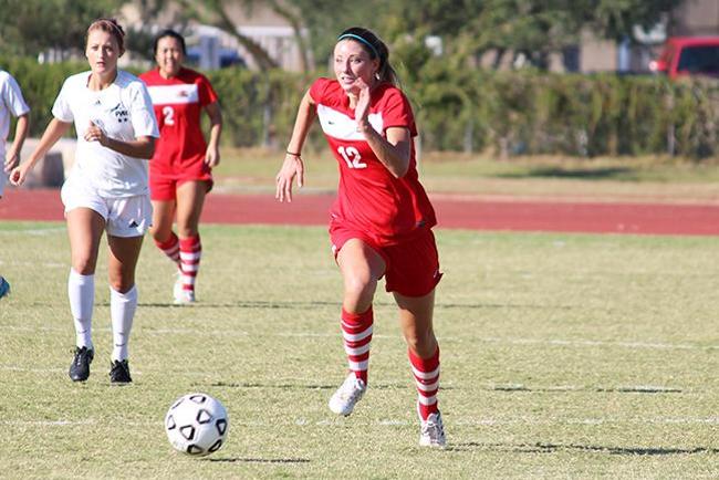 Morgan Eddy(#12) dribbles down the field (photo by Aaron Webster)