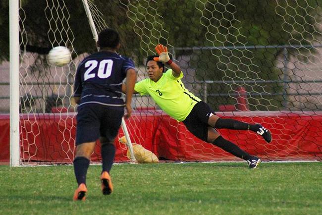 Goalie Brandon Alvarez attempts to block a kick Tuesday night against Pima.